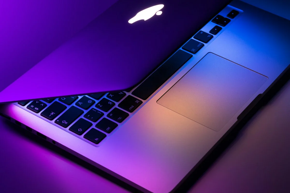 Laptop keyboard under purple lighting