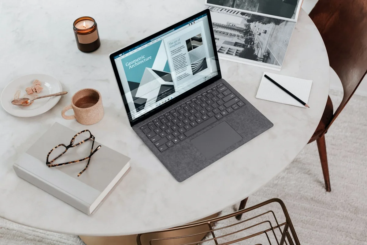 Laptop and glasses on a round table